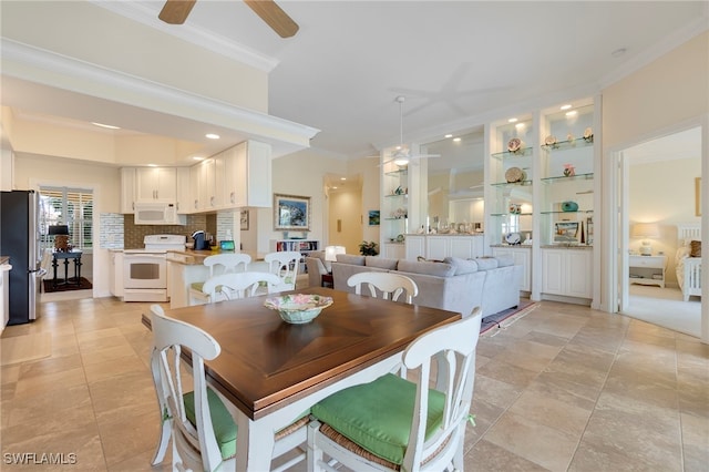 dining room featuring ceiling fan and ornamental molding