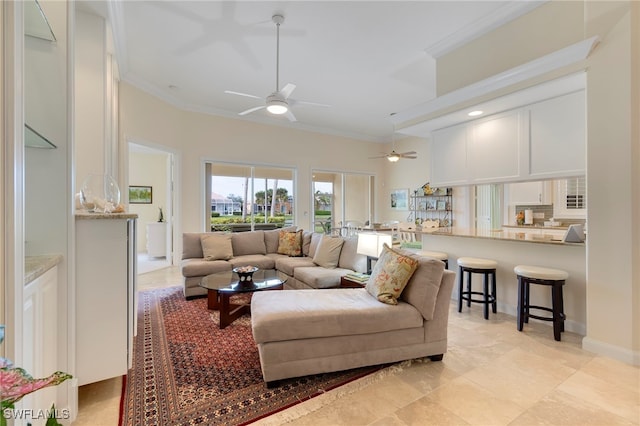 living room featuring ceiling fan and ornamental molding