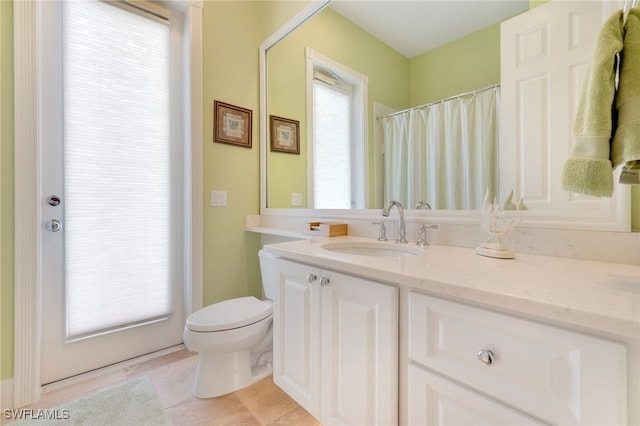 bathroom with tile patterned floors, vanity, and toilet