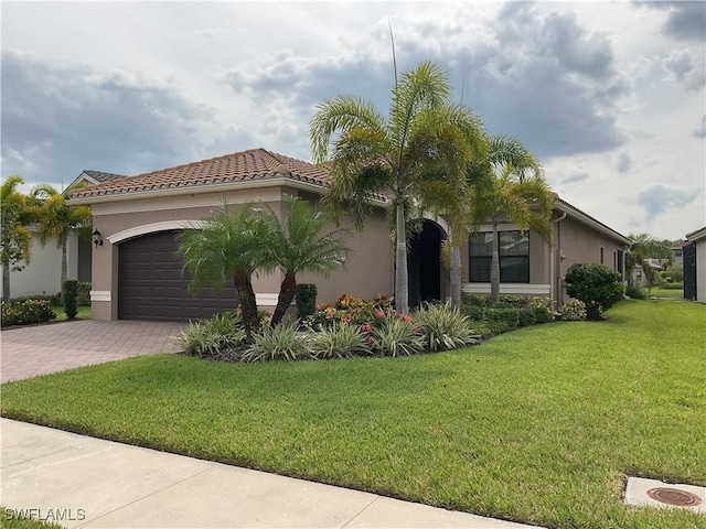 mediterranean / spanish home with a garage and a front yard