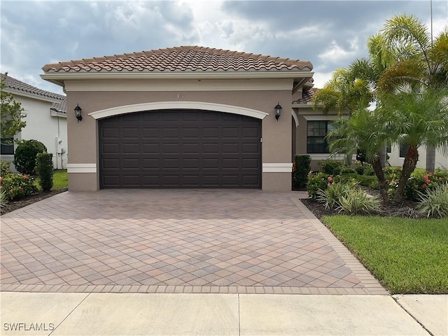 mediterranean / spanish-style home featuring a garage