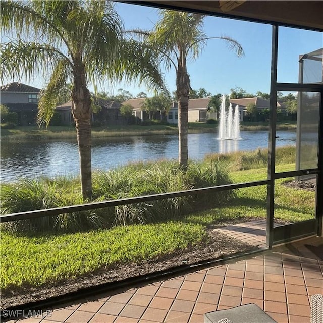 unfurnished sunroom featuring a water view