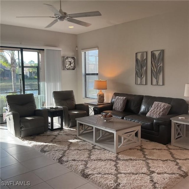 tiled living room with ceiling fan and a healthy amount of sunlight