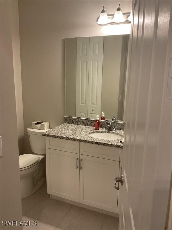 bathroom with tile patterned floors, vanity, and toilet