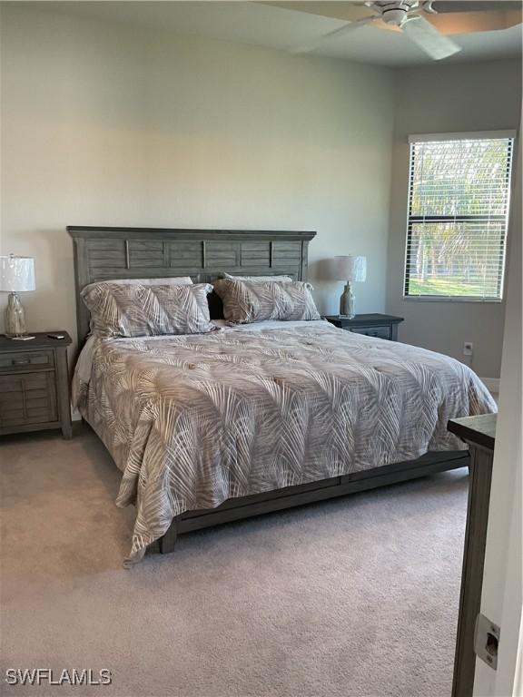 carpeted bedroom featuring ceiling fan