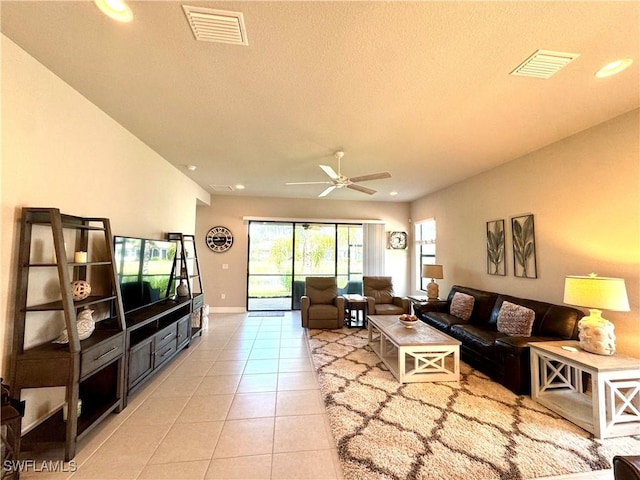 living area featuring recessed lighting, light tile patterned flooring, visible vents, and a ceiling fan