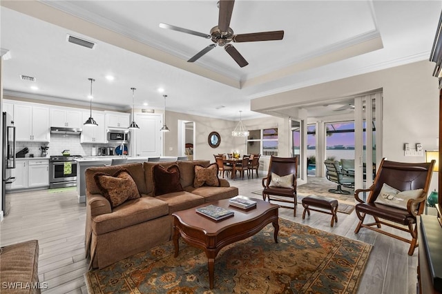 living room featuring light wood-type flooring and ornamental molding