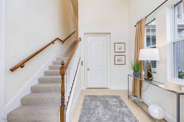 stairway with tile patterned floors