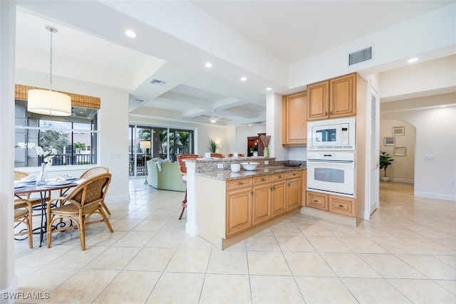 kitchen featuring white appliances, kitchen peninsula, light stone countertops, decorative light fixtures, and ceiling fan