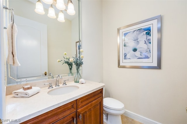 bathroom with toilet, tile patterned flooring, and vanity