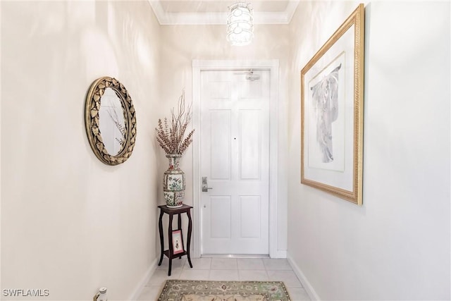 entryway with light tile patterned floors and crown molding