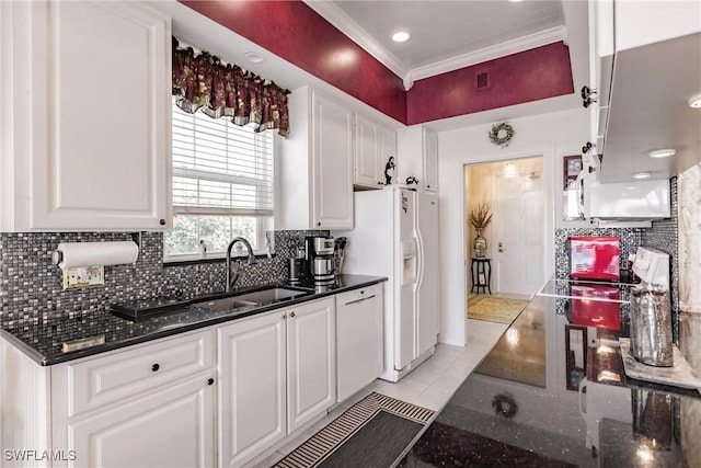 kitchen featuring white cabinets, light tile patterned floors, sink, and dark stone counters