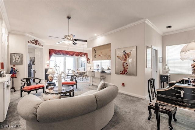 living room featuring carpet, ceiling fan, and ornamental molding