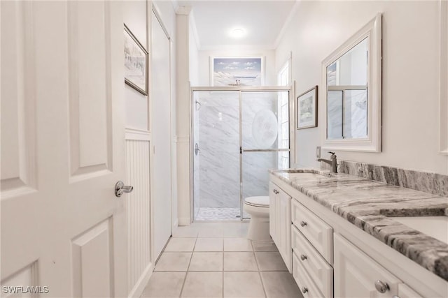 bathroom with toilet, crown molding, tile patterned flooring, and walk in shower