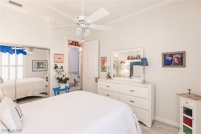 bedroom featuring ceiling fan, light wood-type flooring, and ornamental molding