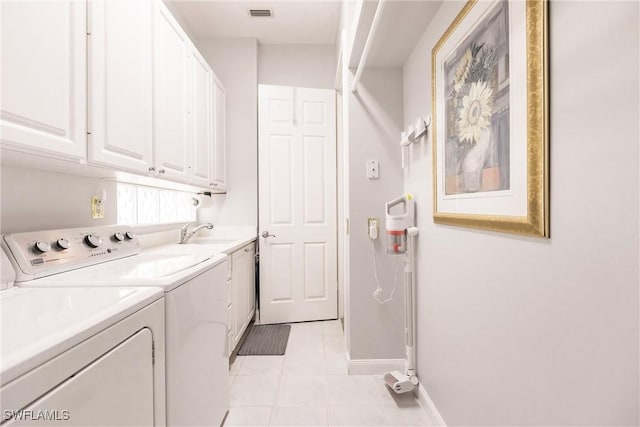 laundry room featuring cabinets, light tile patterned floors, washer and dryer, and sink