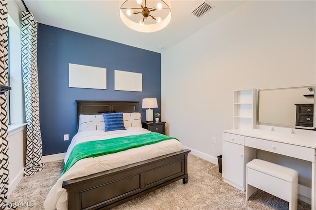 carpeted bedroom featuring a notable chandelier