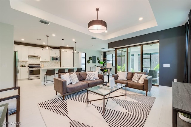 living room with a tray ceiling