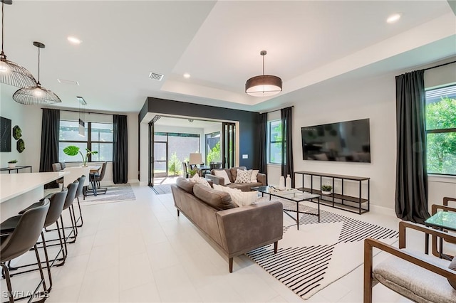 living room featuring a raised ceiling