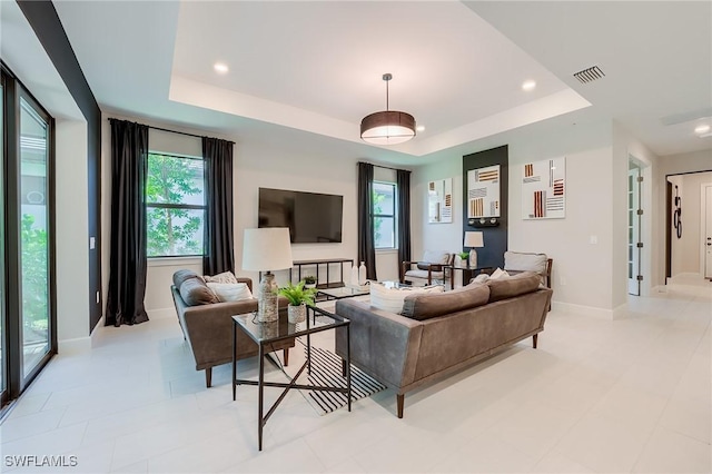 living room featuring a raised ceiling