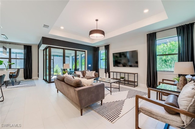 living room featuring a raised ceiling