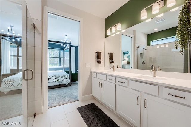 bathroom with tile patterned floors, plenty of natural light, vanity, and a chandelier