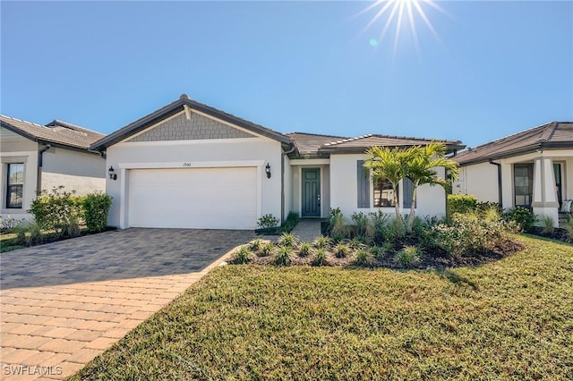 single story home with a garage and a front lawn