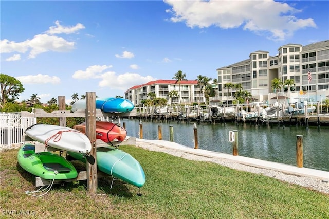 view of dock featuring a water view and a yard