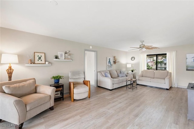 living room with light hardwood / wood-style floors and ceiling fan