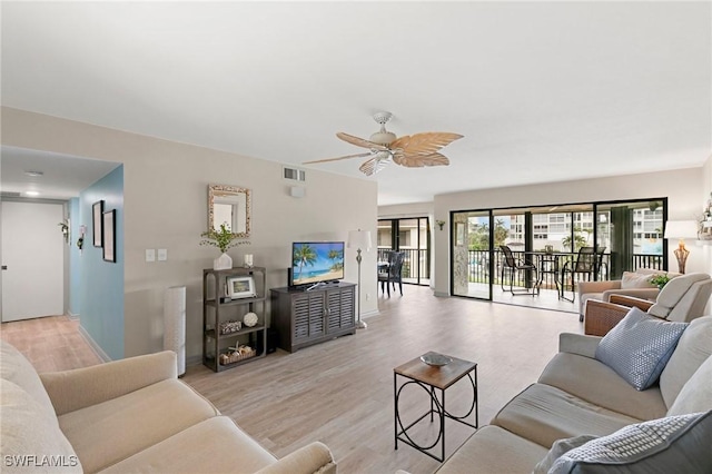 living room with light wood-type flooring and ceiling fan