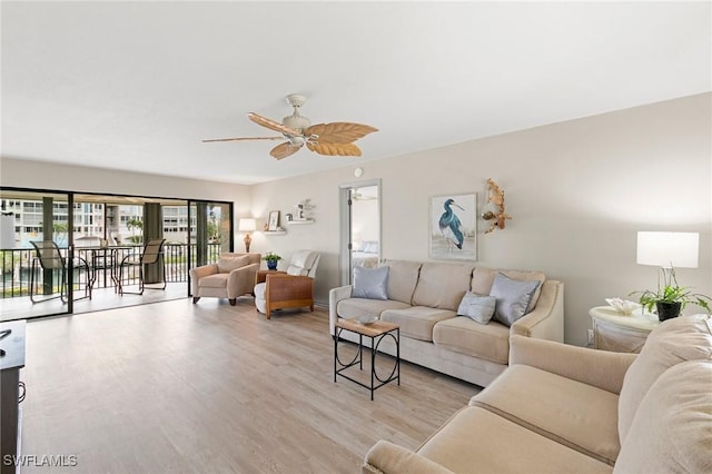 living room featuring ceiling fan and light hardwood / wood-style flooring