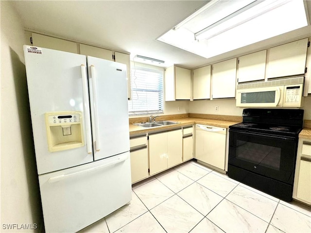 kitchen featuring cream cabinets, sink, and white appliances