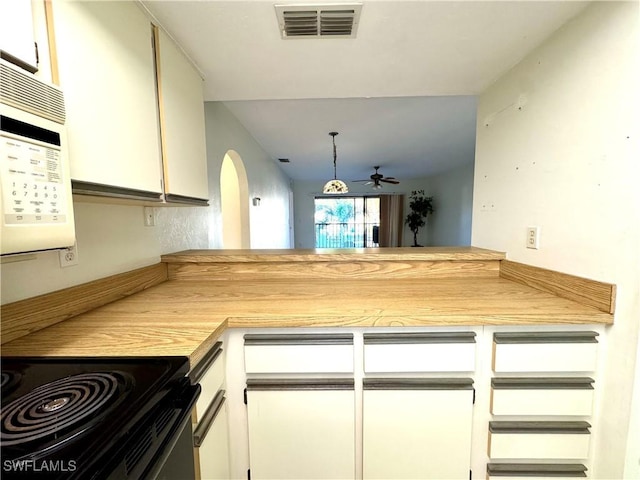 kitchen featuring white cabinets, pendant lighting, kitchen peninsula, and ceiling fan