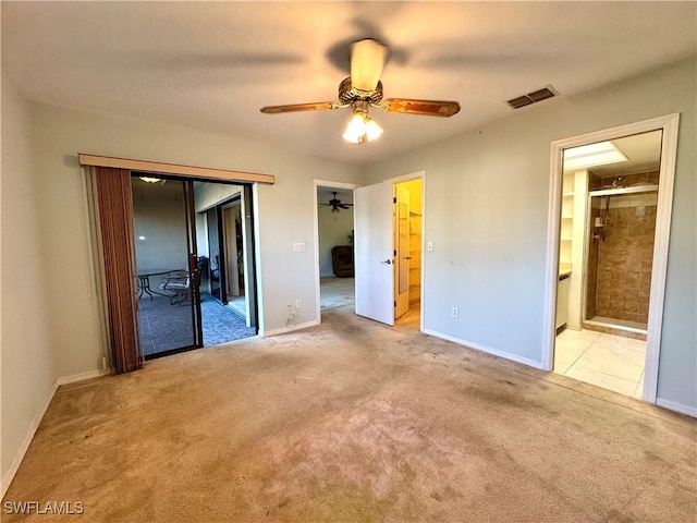 unfurnished bedroom with light carpet, ensuite bath, and ceiling fan