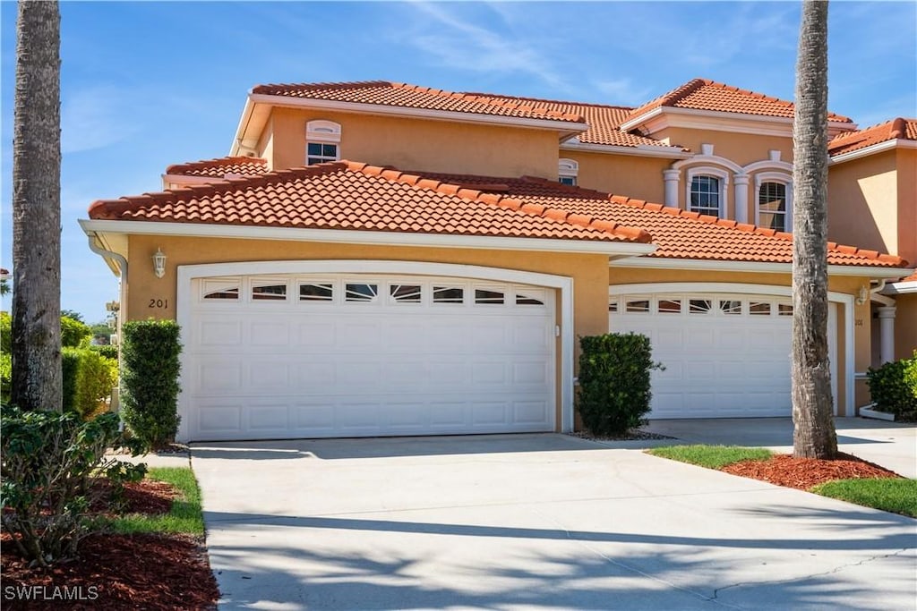 mediterranean / spanish-style house featuring a garage