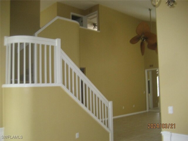 stairway featuring ceiling fan