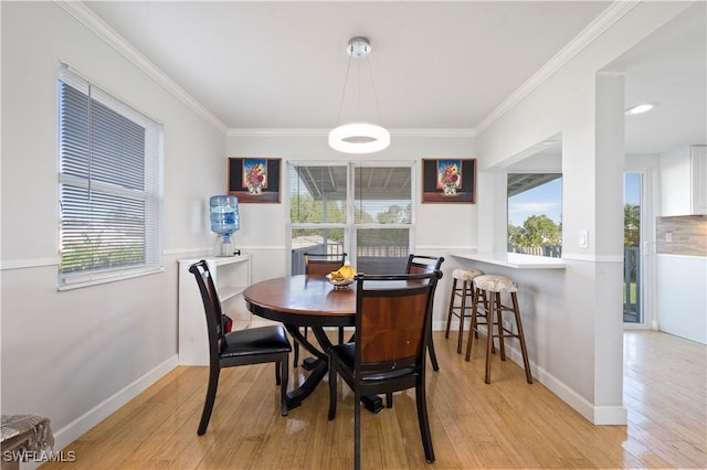 dining area featuring light hardwood / wood-style flooring and ornamental molding