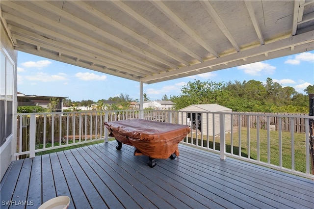 wooden terrace with a yard and a shed