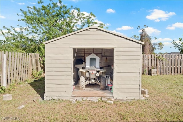 view of outbuilding with a yard