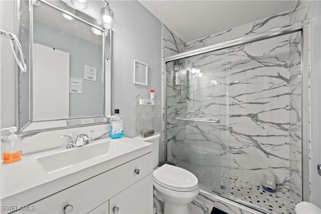 bathroom with an enclosed shower, vanity, and toilet