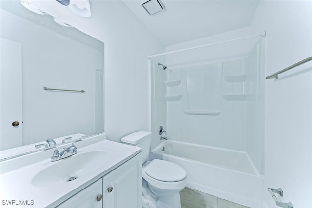 full bathroom featuring shower / tub combination, vanity, toilet, and tile patterned floors