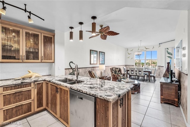 kitchen with kitchen peninsula, dishwasher, ceiling fan, sink, and light tile patterned flooring