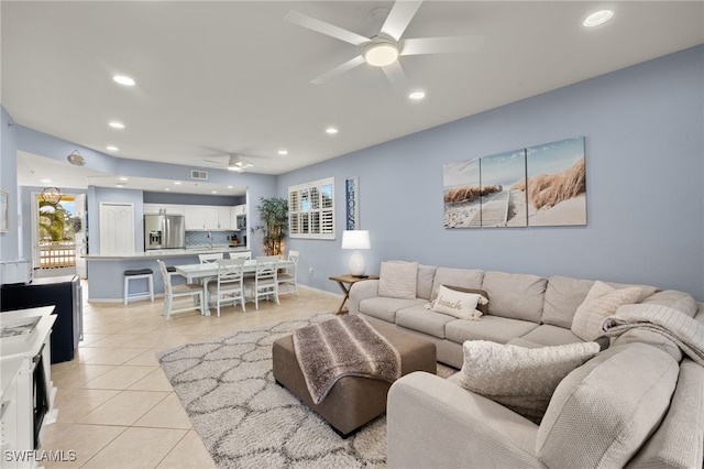 living room with ceiling fan and light tile patterned floors