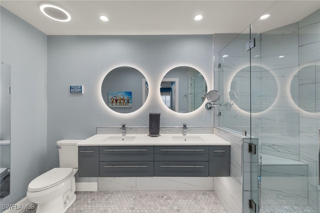 bathroom with tile patterned flooring, vanity, toilet, and an enclosed shower