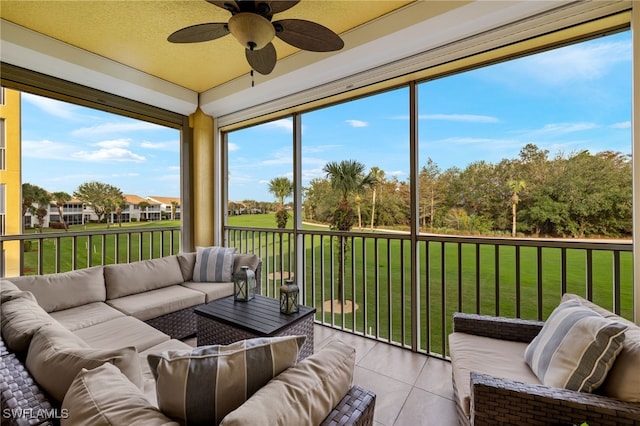 sunroom / solarium featuring ceiling fan