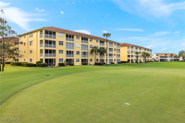 view of home's community featuring a lawn