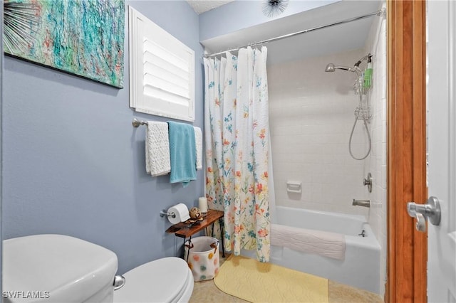 bathroom with tile patterned floors, shower / bath combo, and toilet