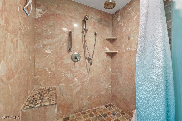 bathroom with tiled shower