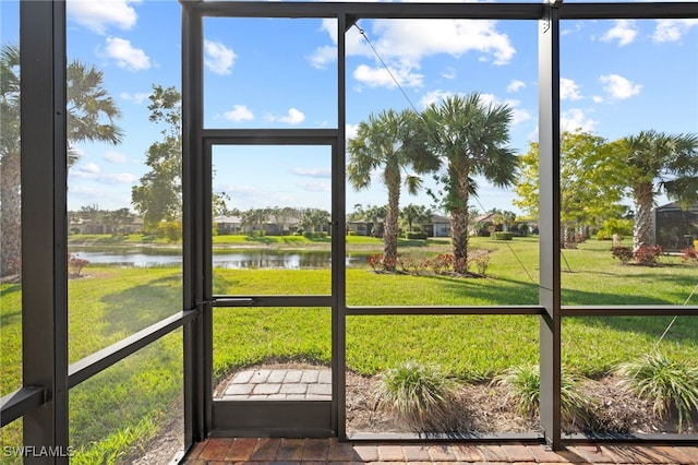 unfurnished sunroom with a water view