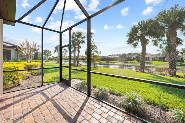 unfurnished sunroom featuring a water view